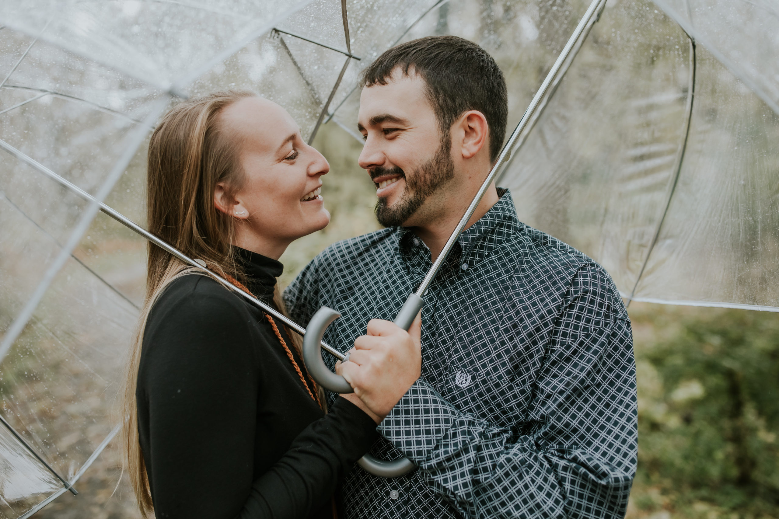 Couple under umbrella engagement photos